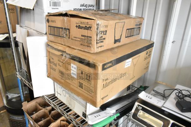 Boxes of Acopa 7 oz. Martini Glasses, Libbey Endeavor 12 oz Double Old Fashioned Glasses, and Bormioli Rocco Maxi Tumblers.
