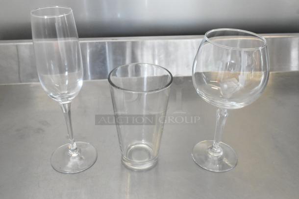 Three brand new glasses: Acopa 8 oz. flute, Libbey 16 oz. pint, and Libbey 19.5 oz. gin & tonic glass, on display.