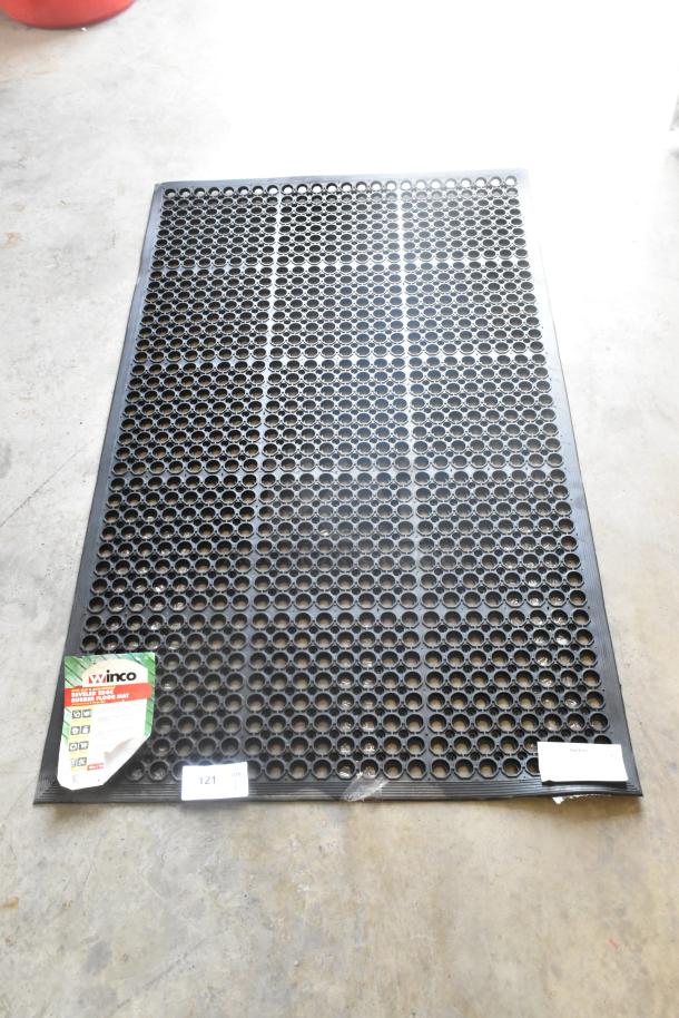 Brand new Winco RBM-35K black anti-fatigue mat, perforated surface, minor scratches and dents, retail tag visible.