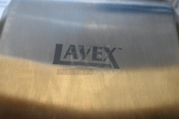 Lavex stainless steel automatic hand dryer, model 158LAVHDSSS, showing brand logo. New condition with scratch and dent.