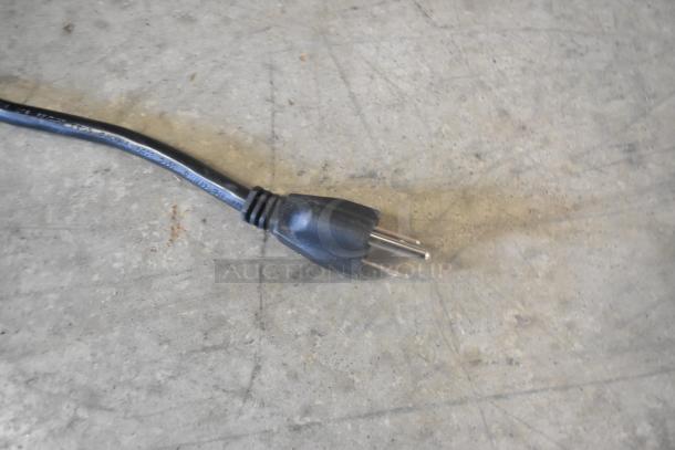 Power cord of a Lavex hand dryer on concrete surface, part of lot including Lavex White and Satin Stainless Steel models.