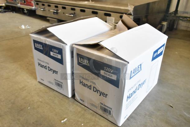 Two Lavex automatic hand dryers in damaged boxes, models 158LAVHDSSW (White) and 158LAVHDSSS (Silver), 110/120V, 1,350W.