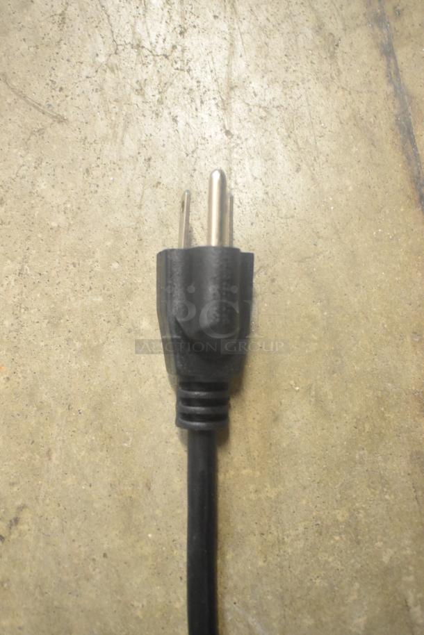 Close-up of a black electrical plug for the 2025 ServIt 423HSW2024 Stainless Steel Heated Shelf Warmer, 120 Volts.