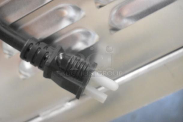 Close-up of the Avantco 177HEAT1836I heating cabinet's power cord and metal surface, illustrating new condition.