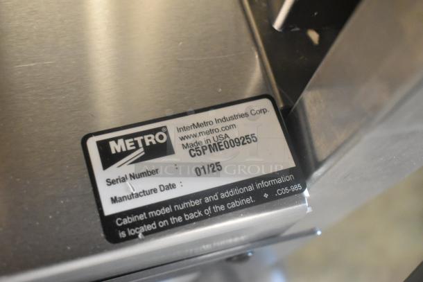 Alt text: 2025 Metro C519-PFC-U Non-Insulated Proofing Cabinet with serial label, showing commercial casters and voltage specs.