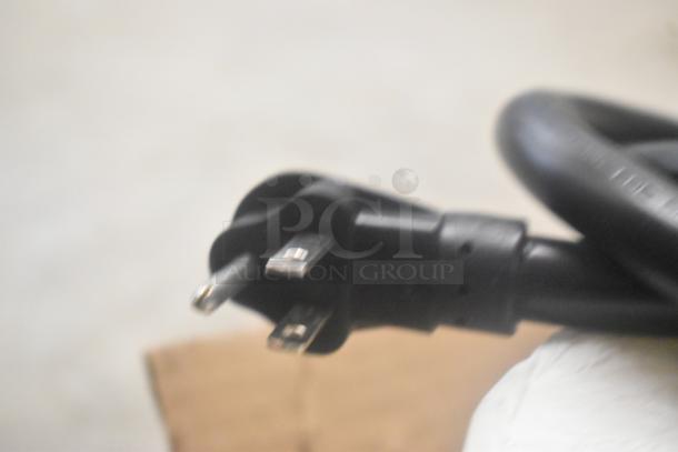 Close-up of a black power cord plug for a Metro C519-PFC-U Proofing Cabinet, 120V, 1 Phase, on commercial casters.
