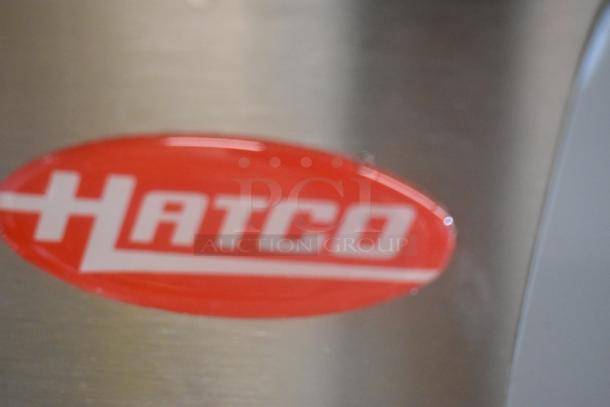 Hatco GRHD-4PD logo on stainless steel surface; brand new scratch and dent. Dual shelf merchandiser, 120/208V, 1 Phase.