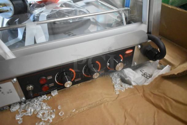 Hatco GRHD-4PD stainless steel merchandiser, brand new, scratch and dent, 120/208V, 1 phase, dual shelf controls visible.