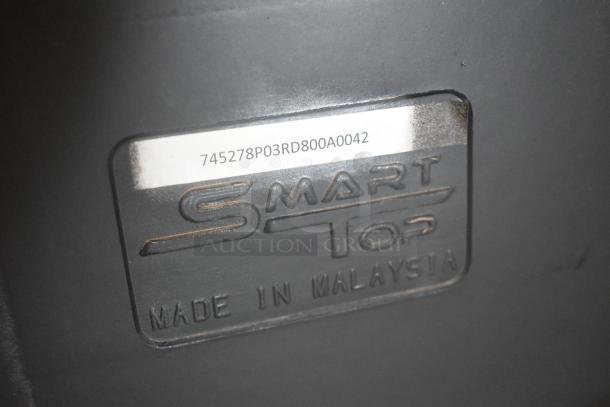 Close-up of a "Smart Top" label reading "Made in Malaysia" with a serial code 745278P03RD800A0042 above it.