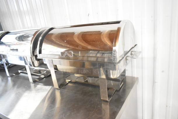 Stainless steel chafer, scratch and dent, new condition, reflective surface, catering equipment on a metal table.