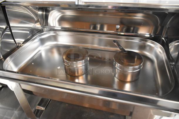 3 brand new scratch and dent stainless steel chafers, includes two serving utensils, reflective finish.