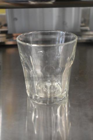Set of 16 brand new beverage glasses, scratch and dent condition, clear glass, durable design, ideal for everyday use.