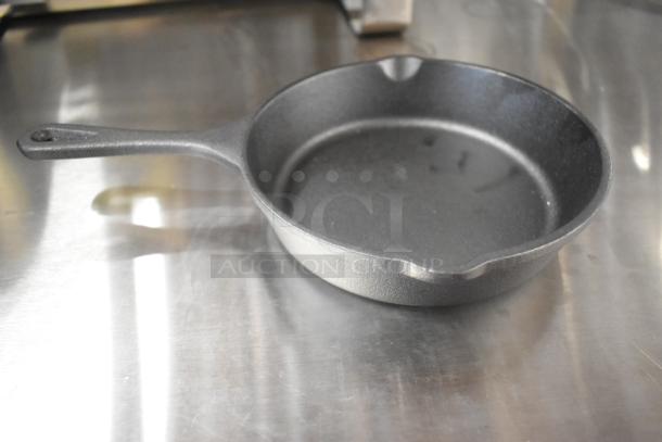 Valor cast iron skillet, brand new, with minor scratches and dents. Durable and versatile kitchen cookware.