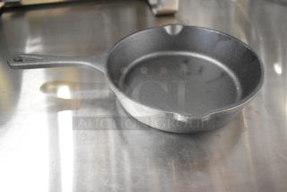 Valor cast iron skillet, brand new, with minor scratches and dents. Durable and versatile kitchen cookware.