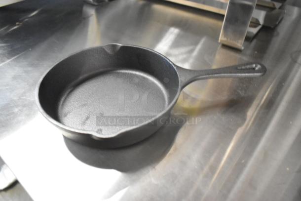 Valor cast iron skillet, new condition, minor scratches, 12-inch size, durable cookware. Auction lot of 12 skillets.