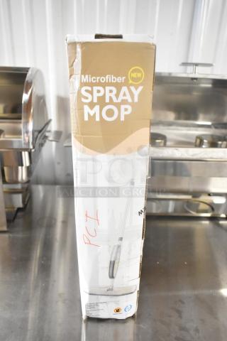 Brand new spray mop in slightly damaged box, labeled "Microfiber New," features spray mechanism. Box marked with "PCT."