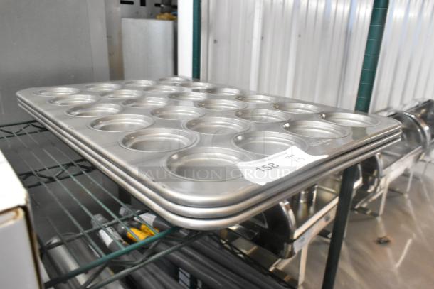 3 new metal 24-cup muffin pans, slightly scratched, ideal for bulk baking. Labeled "158, QTY x3" for auction.