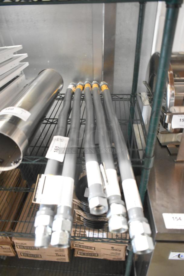 Five brand new Dormont Ultra Flow gas hoses on a shelf, each with visible tags indicating "Scratch and Dent" condition.