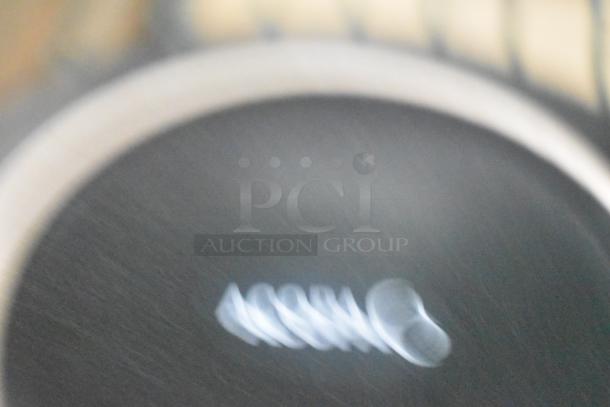 Blurred image of Acopa black plates. Marking reads "Acopa." Auction item, 36 scratch and dent plates available.