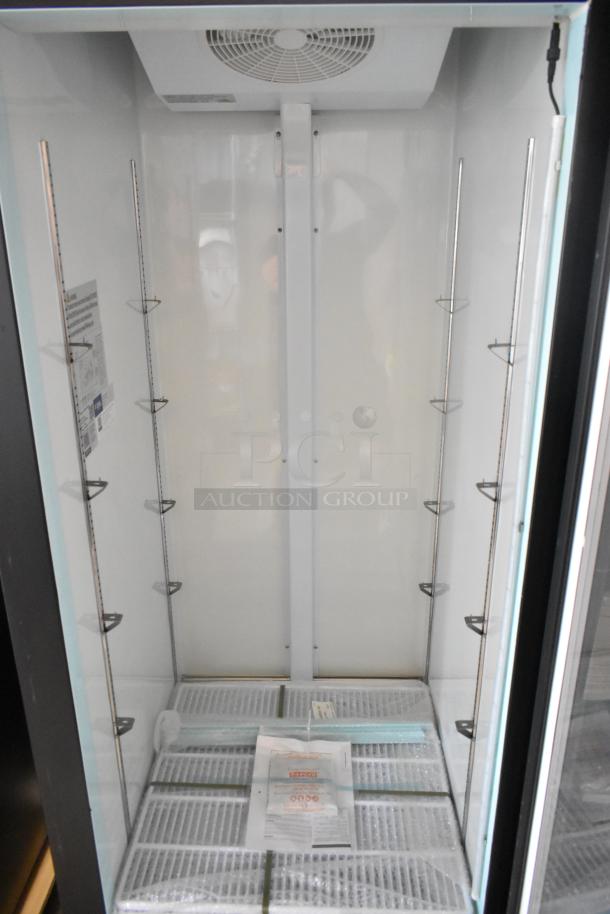 Brand new Avantco 178GDC24FHCB 31" black swing glass door merchandiser freezer with LED lighting, 115V, customizable.
