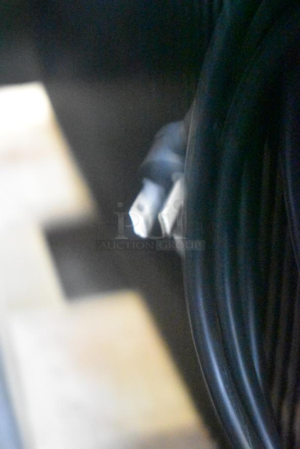 Blurred close-up of a cable for the True TOAM-48GS-HC refrigerated merchandiser. No clear view of item features.