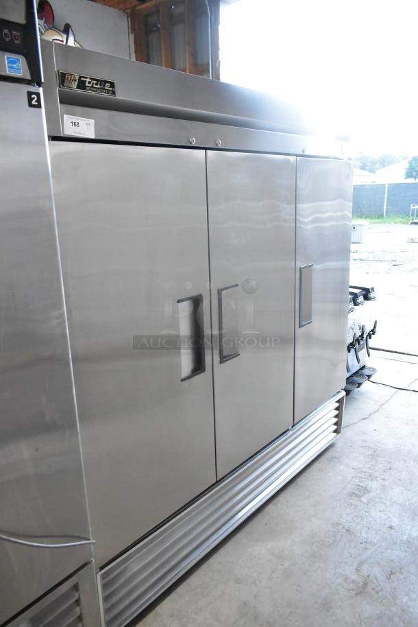 True T-72 stainless steel commercial 3-door reach-in cooler, 115 volts, 1 phase, showing sturdy door handles and sleek design.