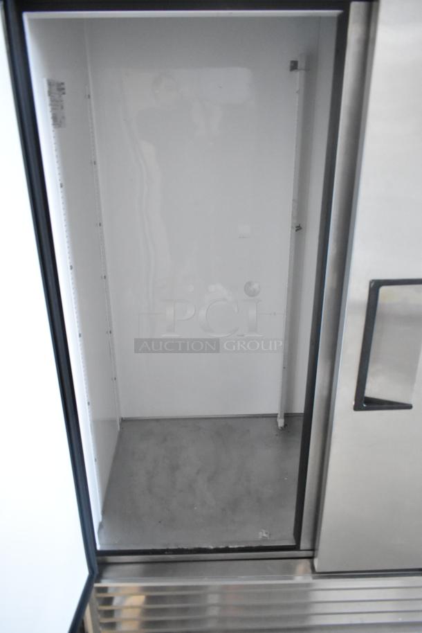 True T-72 stainless steel commercial 3-door reach-in cooler, empty interior view, model label partially visible, 115V, 1 phase.