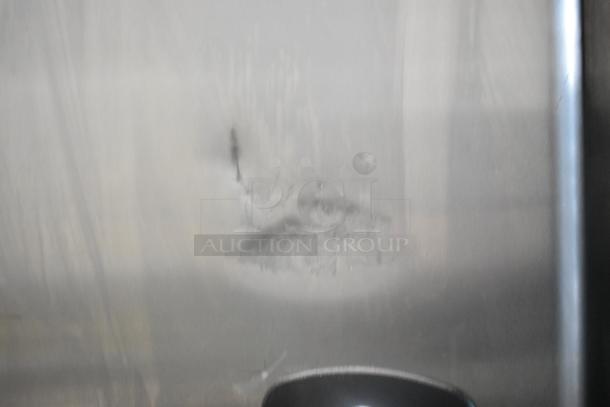 Kool Star KSR49-S stainless steel reach-in cooler, visible dent on the surface, on commercial casters, 115 volts, 1 phase.