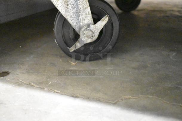 Close-up of a commercial caster on the Beverage Air HF2-1S stainless steel freezer, showing durability for mobility.