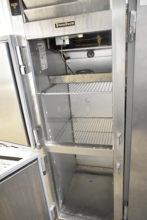 Traulsen ALT132DUT-HHS stainless steel freezer with 2 half doors, commercial casters; clean interior, 115V, 1 phase.