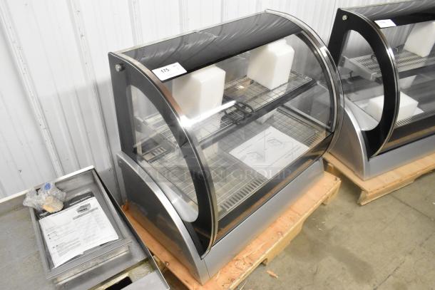 Brand new Vollrath HDE8136 36" countertop curved glass heated display cabinet, 120V, 1 Phase, shows minor scratches.