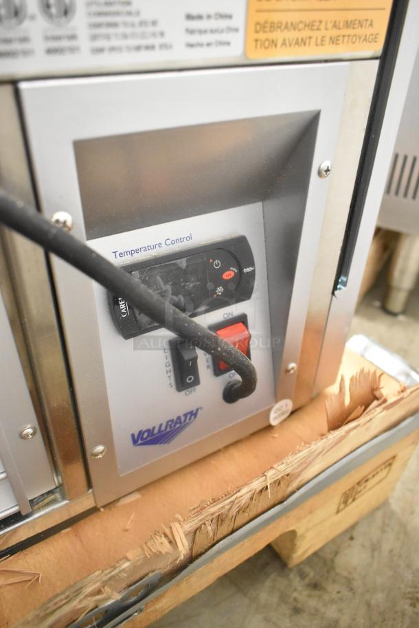 Vollrath HDE8136 36" countertop display cabinet control panel with temperature settings. Tags indicate voltage and maintenance instructions.