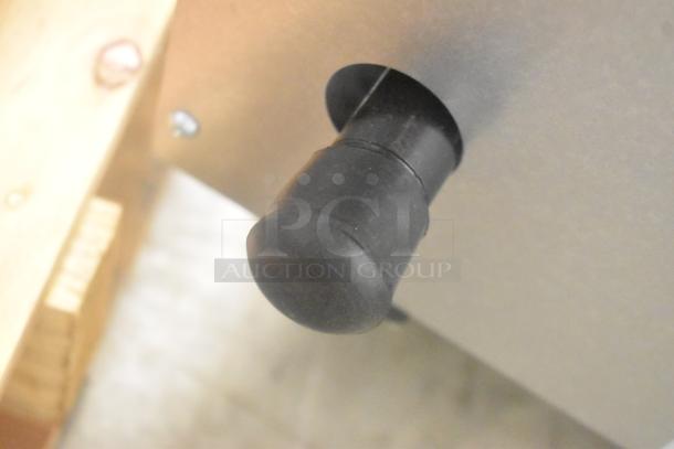 Close-up of a control knob on the Vollrath Cayenne FTG-9048 stainless steel commercial griddle.