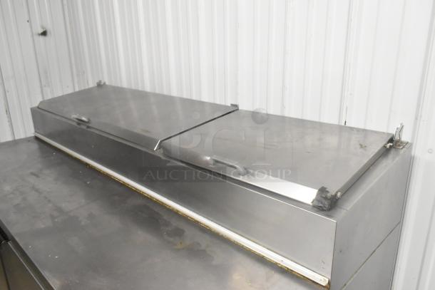 Beverage Air DP67 stainless steel pizza prep table, commercial casters, 115V, 1 phase, showing minor wear on the surface.
