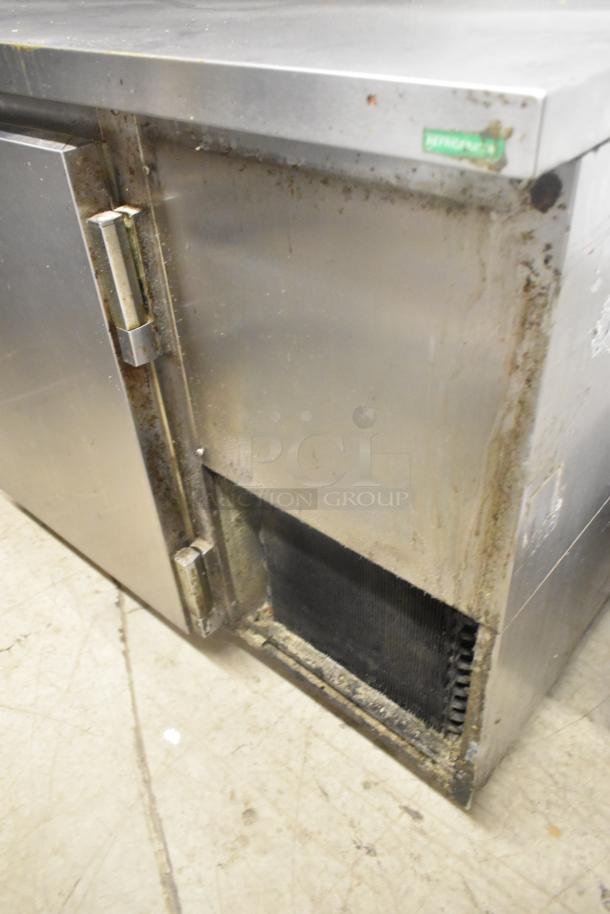 Beverage Air DP67 stainless steel pizza prep table, showing surface wear, on commercial casters. 115 Volts, 1 Phase.