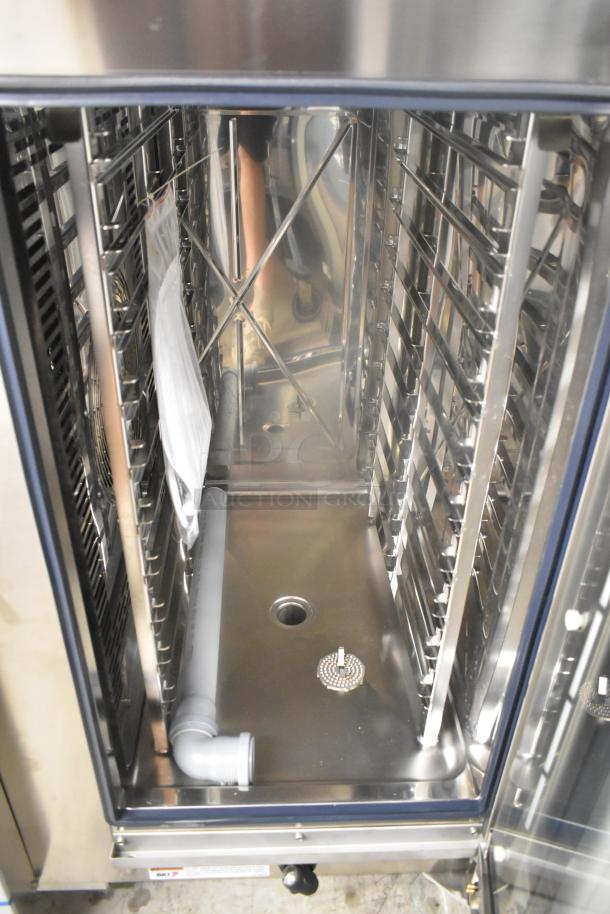 Brand new Blodgett AETG101R stainless steel commercial combi oven, interior view, slight scratches, ample rack space.