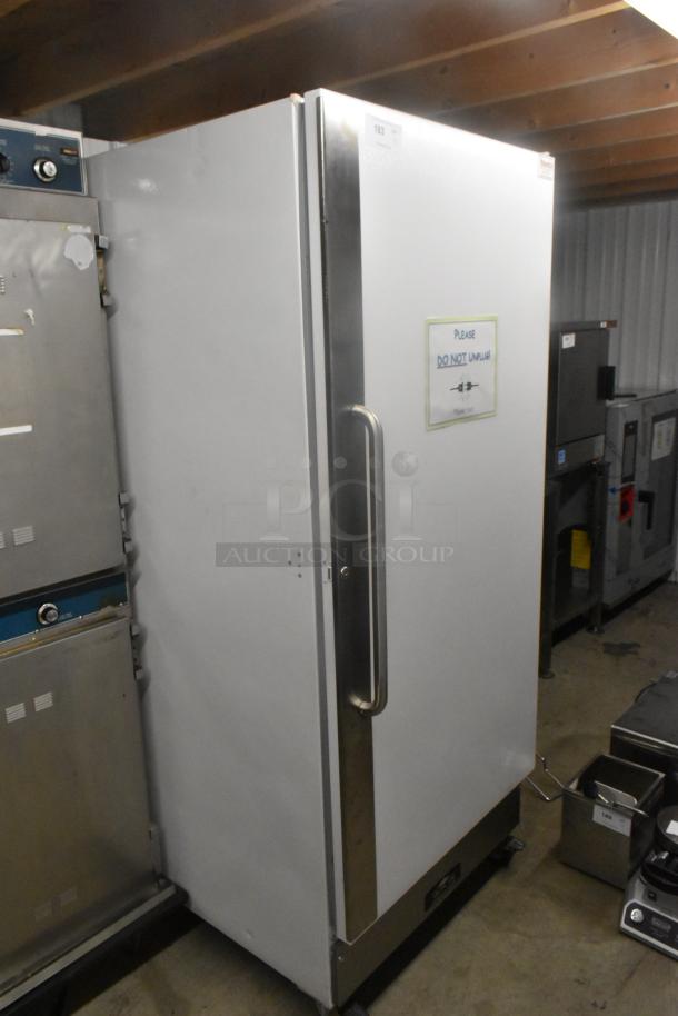 Arctic Air F22CWF3 single door reach-in freezer on commercial casters, 115 volts, 1 phase, with "Do Not Unplug" sign.