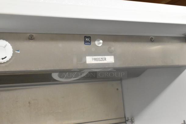 Arctic Air F22CWF3 single door reach-in freezer, stainless steel, NSF label visible, on commercial casters, 115V.