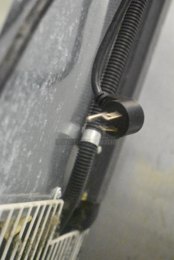 Arctic Air F22CWF3 freezer power cord and plug detail, showing part of the unit's metal back panel and wired connections.