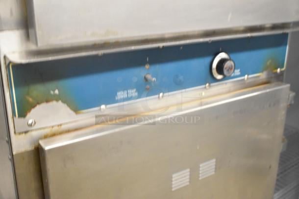 Alto Shaam 1000-TH-I stainless steel commercial Cook N Hold oven on casters, 208-240 volts, showing wear and age marks.