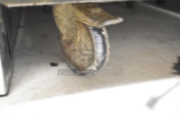 Alto Shaam 1000-TH-I oven caster detail; shows wear and condition of commercial-grade wheel.