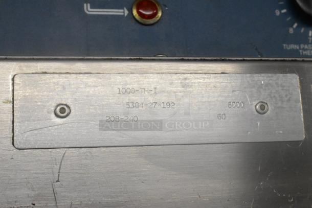 Alto Shaam 1000-TH-I stainless steel label showing voltage 208-240V and model details on commercial oven.