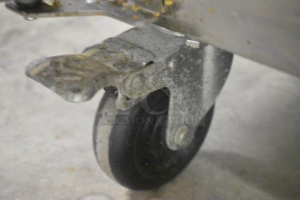 Yukon YPP71 stainless steel pizza prep table on commercial caster, showing wheel detail. 115 volts, 1 phase.