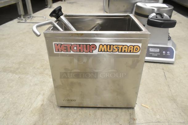 Winco PKTS-2D stainless steel condiment rail with a pump, labeled for ketchup and mustard, shows minor wear.