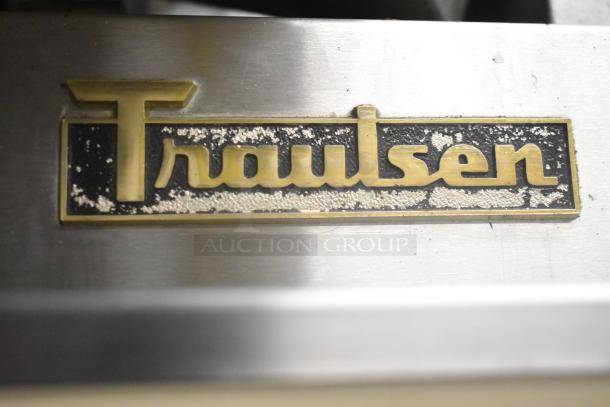 Traulsen RRI 1-32LPUT badge on stainless steel surface, commercial cooler model, showing brand logo.