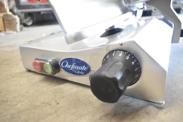 BRAND NEW Globe Chefmate stainless steel commercial meat slicer with blade sharpener, 115 volts, shows speed dial and brand label.