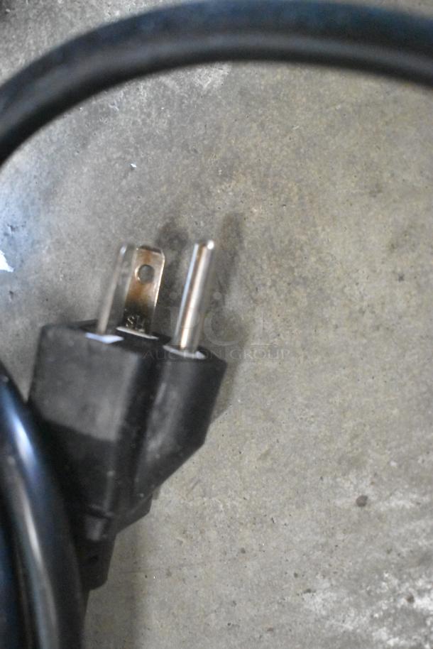 Power cord of Avantco 177EG30N stainless steel commercial griddle, 208/240 volts, 1 phase, shown against concrete floor.