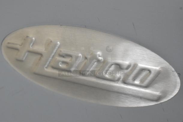 Hatco logo engraved on a metal surface of the GRFHS-PT26 fry holding station, highlighting brand identity.