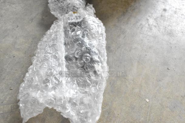 Bubble-wrapped component for Avantco 177HDC26 Heated Display Case, showing part of the item in protective packaging.