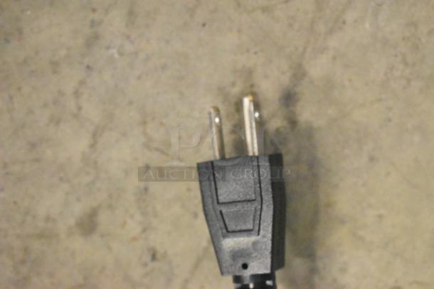 Close-up of a standard two-prong electrical plug, part of the 2024 Carnival King JETCOF 360M beverage dispenser.